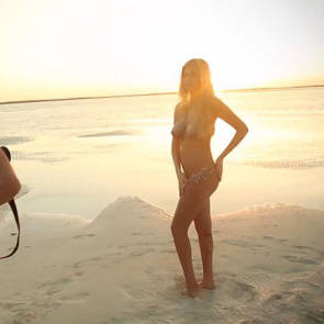 Kate posing with bodypaint on the beach